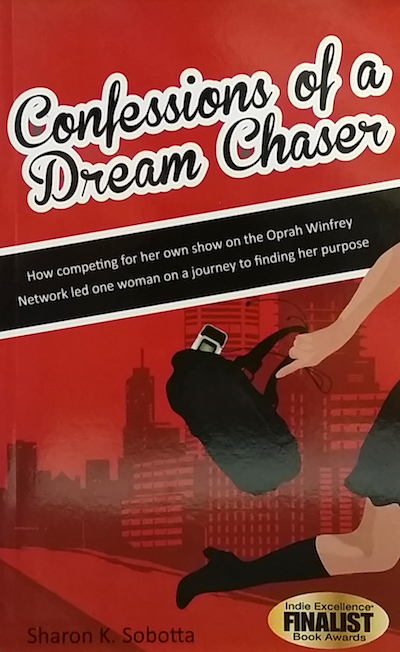 Book cover with woman running in city with cell phone emerging from handbag.