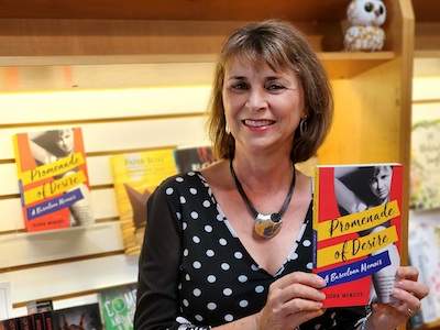 Isidra Mencos holding her book Promenade of Desire at Reasonable Books.