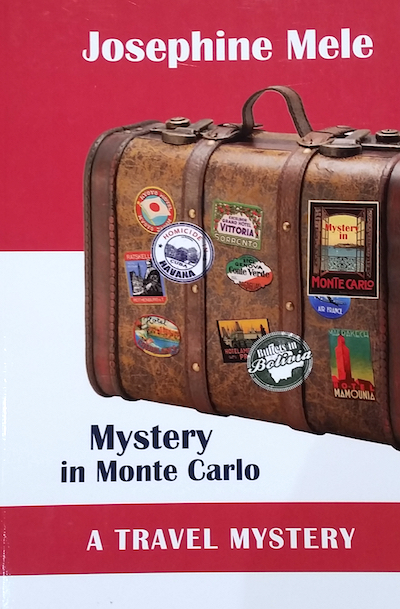 Book cover with antique travel suitcase covered in souvenir stickers.