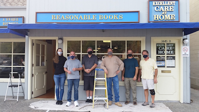 Owners and friends in front of store after installing sign.
